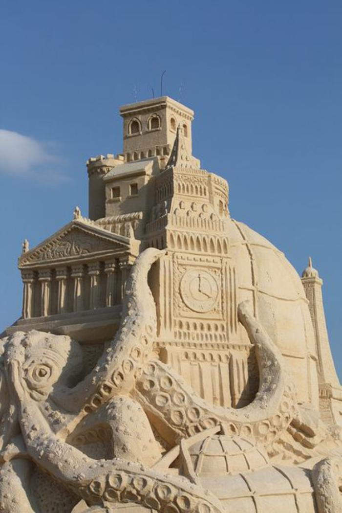 Sand sculpture of-polpo-holding-big-building