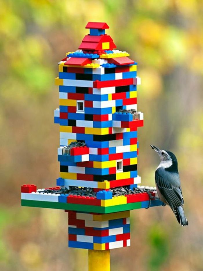 Fare birdhouse da kit, grande idea fai da te per bambini, un uccellino mangia semi di girasole
