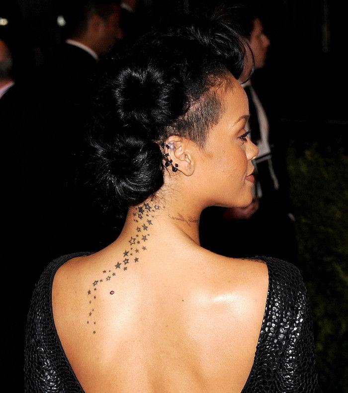 un tatuaggio con molte piccole e grandi stelle bianche e nere - giovane donna e capelli neri