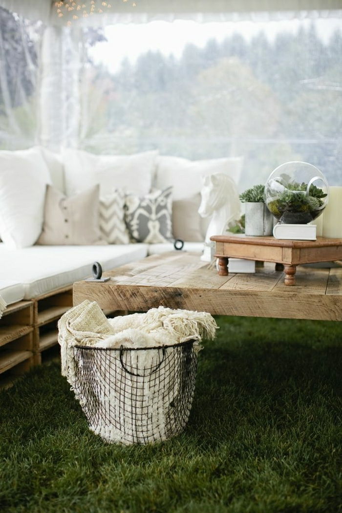 o masă și o canapea din palete vechi cu perne mici și un terarrium - idee de a construi mobilă pentru paleți