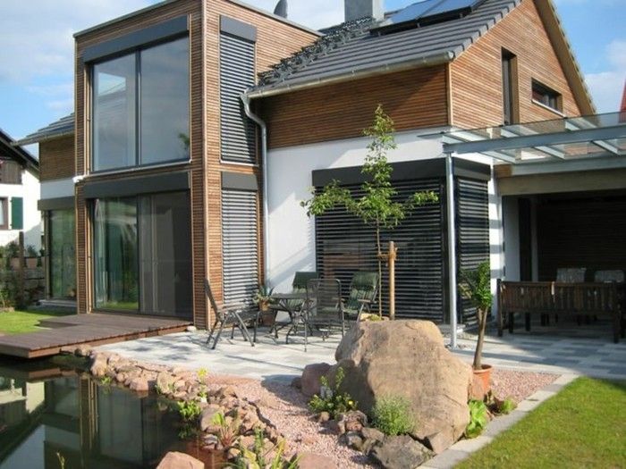 modern trä-house-with-veranda-and-vinterträdgård