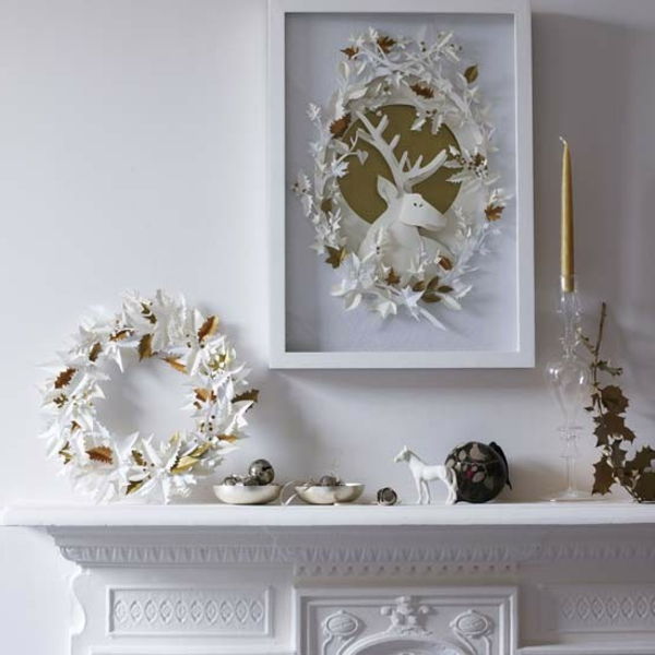 białe świąteczne dekoracje - piękny kominek i białe wianki powyżej