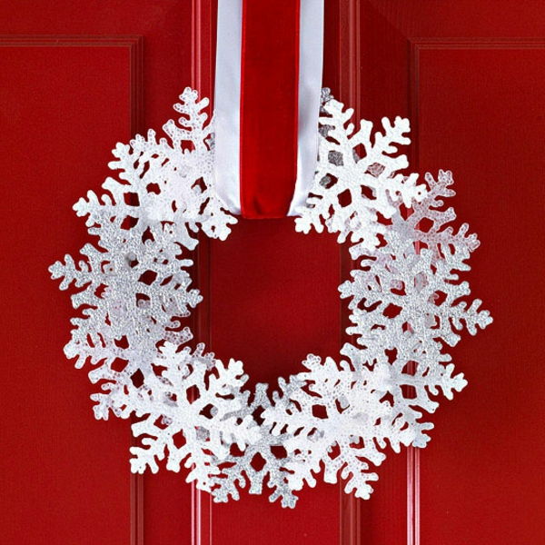 białe świąteczne dekoracje - czerwone drzwi i biały wieniec na nim