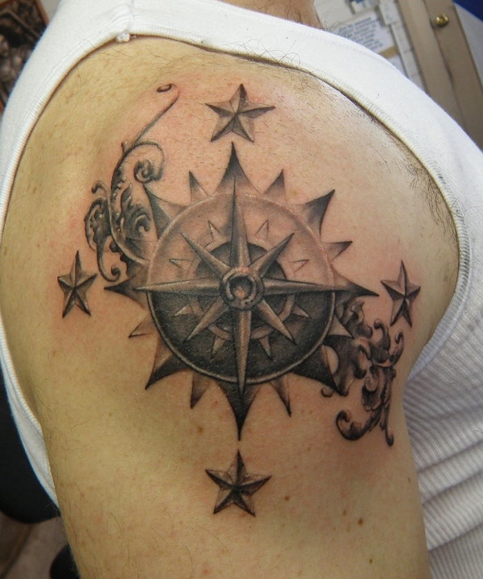 en kompass tattoo på skulderen med fire stjerner - en kompass tattoo for mannen