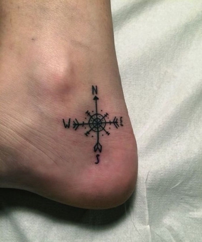 Čia yra labai gražus tatuiruotė su mažu juodu kompasu ant kulno - idėja kompaso tatuiruotė