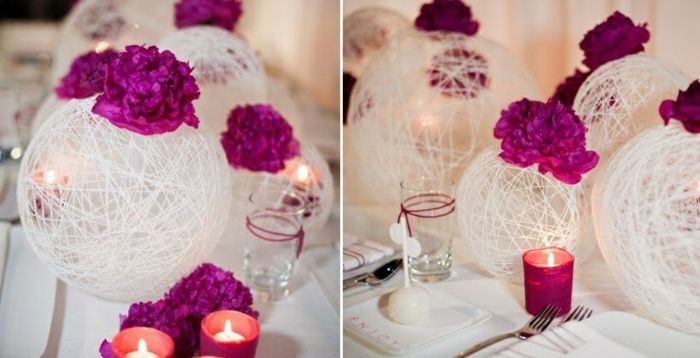 decorazione primaverile. gomitoli di filo con fiori viola, decorazioni da tavola, candele