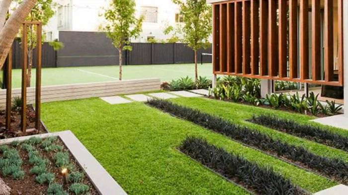 modern trädgård design grönt och svart gräs på gräsmattan