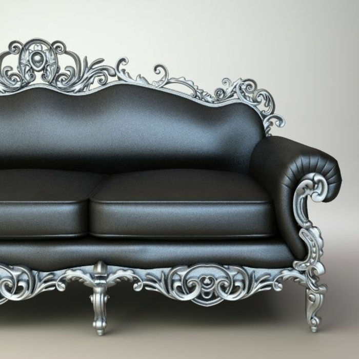 eleganten usnjeni kavč v grafitni barvi z dvema blazinama, kovinske noge v sivi barvi z veliko gotskimi okraski