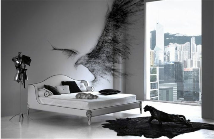 moderna gotska spalnica z belo zakonsko posteljo, stenski grafiti, črna preproga, črna cougar