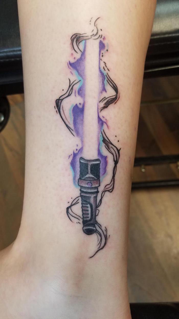 myšlienka tetovania pre ženy - tetovanie hviezdnych vojen s malým fialovým svetelným mečom