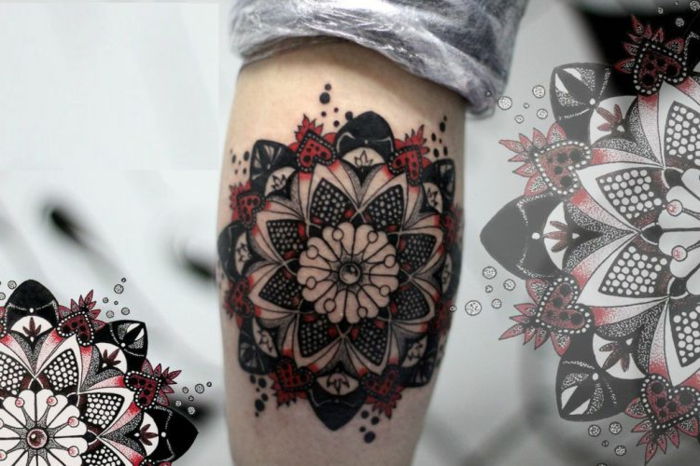 fin arm tatuering i rött och svart med små vita cirklar och svarta prickar i olika storlekar, tatueringsmönster med hjärta och prickmotiv i vitt