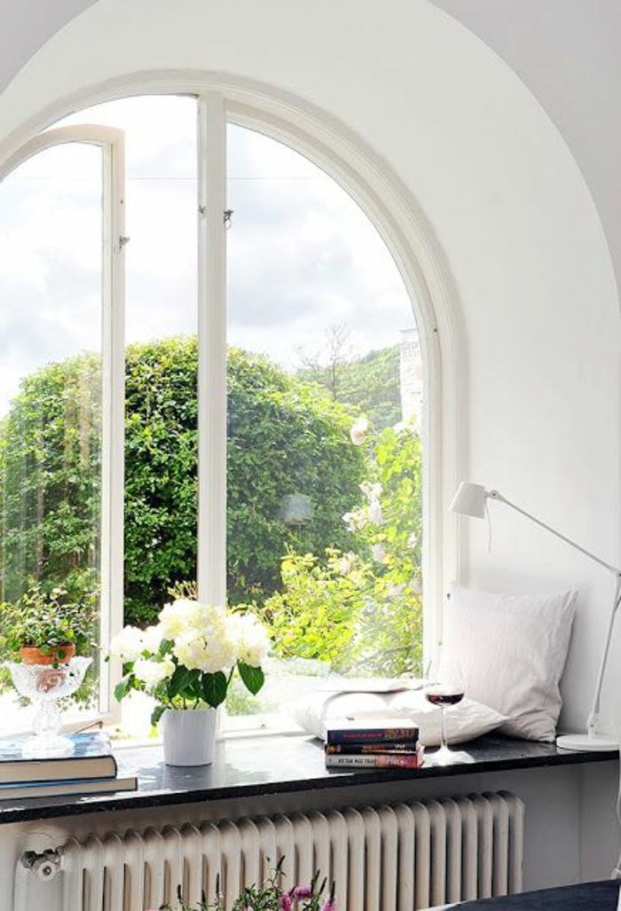 Lâmpada de almofada e vaso de flores no peitoril da janela