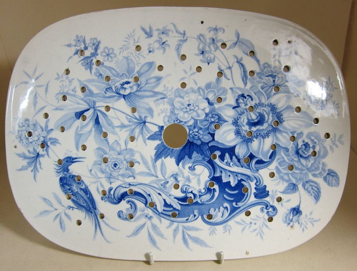 un piatto ovale di ceramica bianca con dipinti astratti in blu