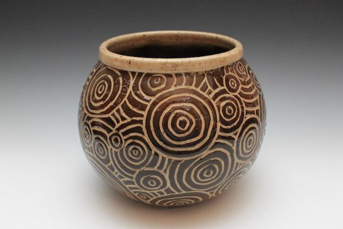 un vaso antico di forma ovale, inciso su argilla, cerchi e spirali