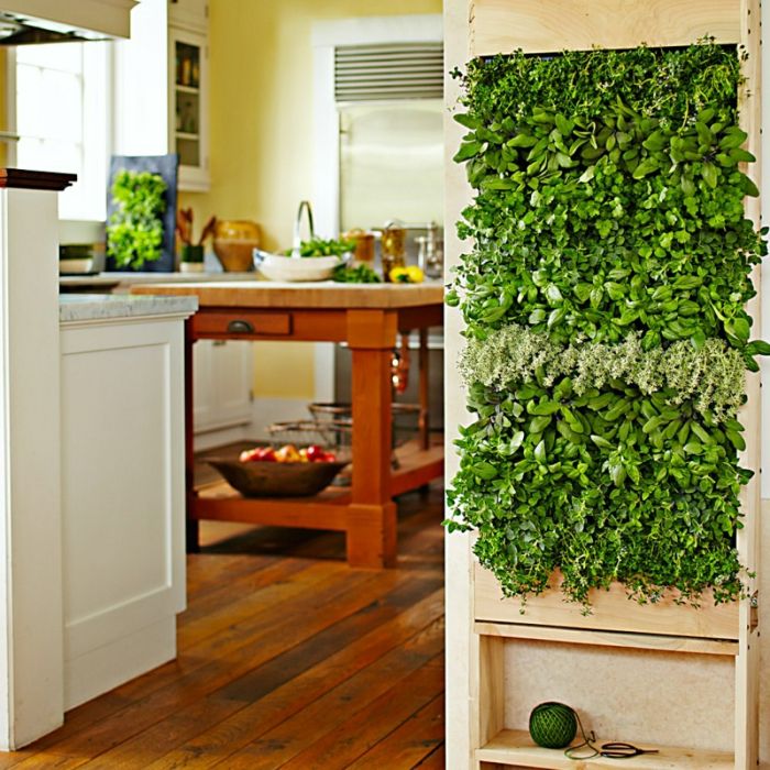 plantera vertikalt i köket, massivt träbord med grön dekoration