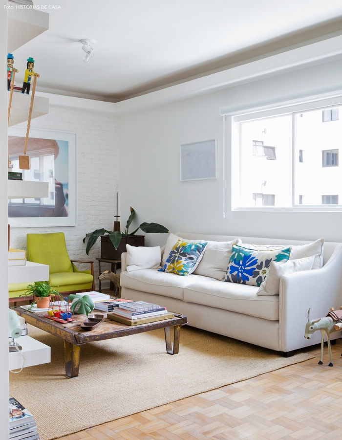 Vintage dnevna soba, bela kavč, barvite dekorativne blazine, majhna miza, houseplants
